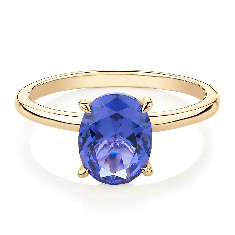 Minimalist Silver Rings-Dress ring with tanzanite simulant in 10 carat yellow gold