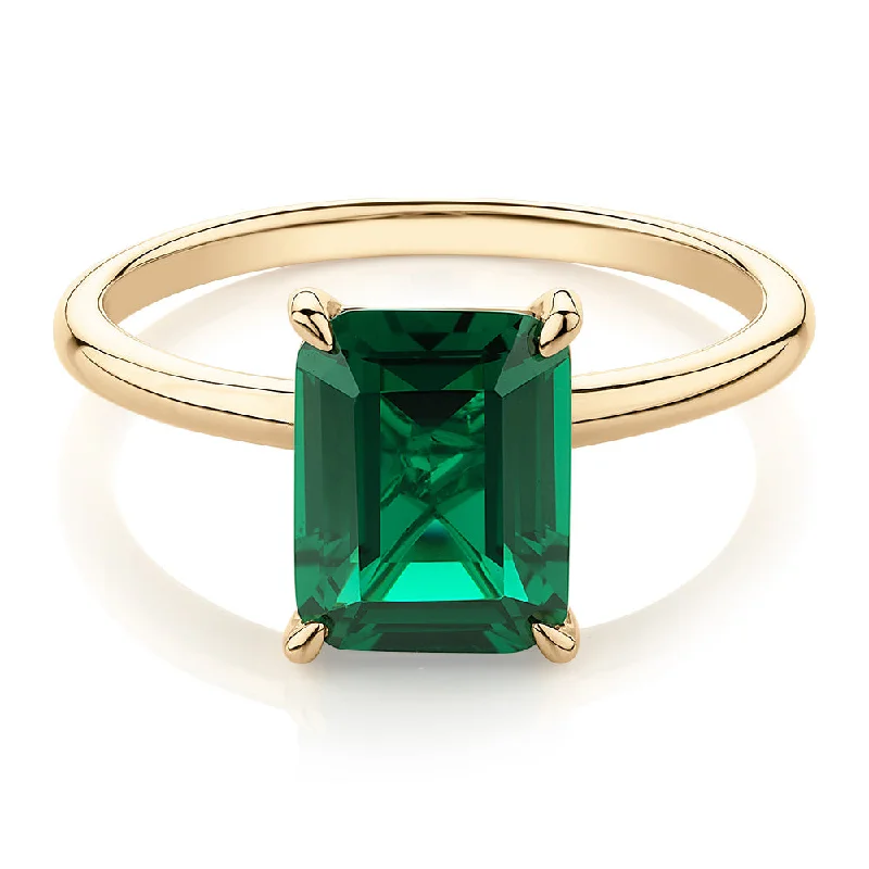 Classic Gemstone Engagement Rings-Dress ring with emerald simulant in 10 carat yellow gold